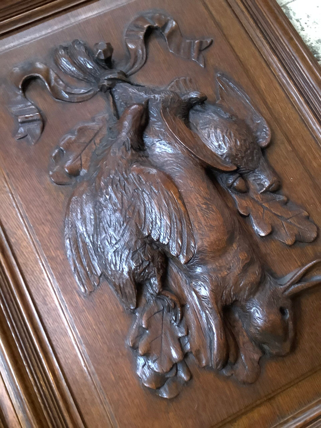 A stunning Antique Handcarved Hunting quarry set on an Oak framed Panel