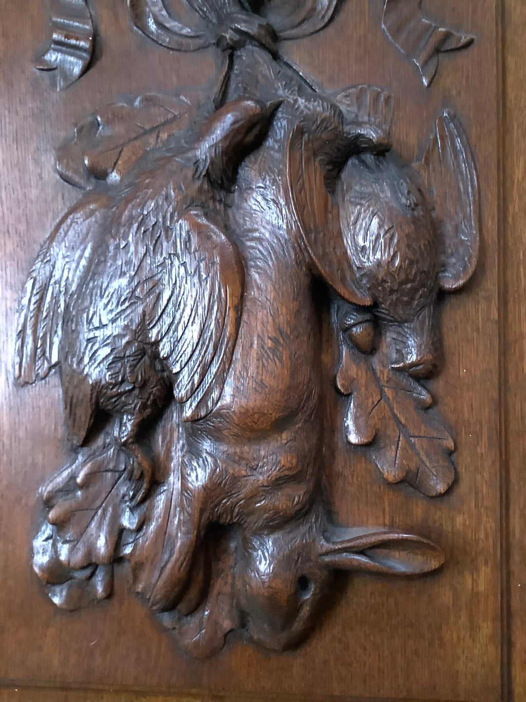 A stunning Antique Handcarved Hunting quarry set on an Oak framed Panel